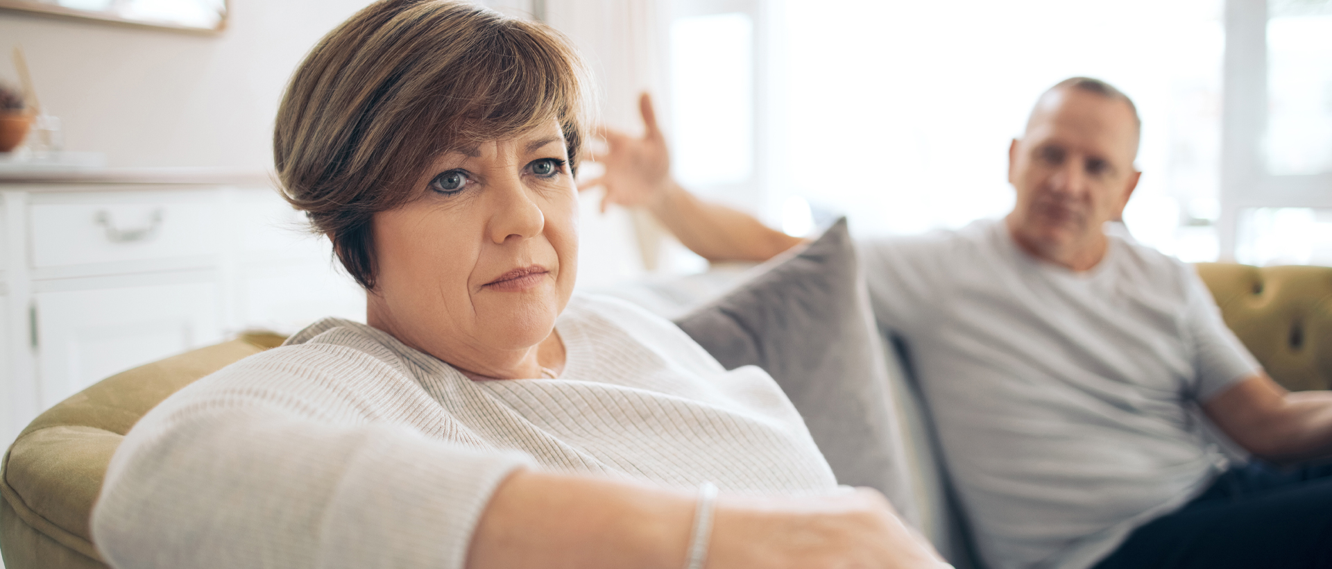 Image of man and woman sitting on couch.