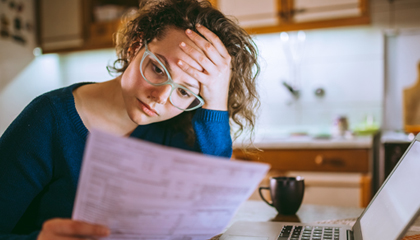 Concerned woman looking at documents.