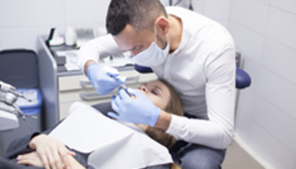 Dentist working on patient.