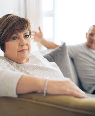 Woman and man sitting on couch.