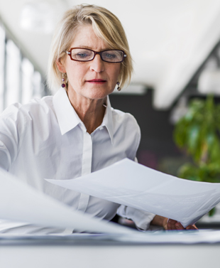 Business woman working at table.