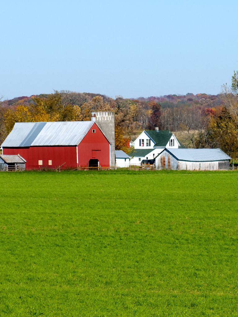 Red barn and farmhouse on farm.