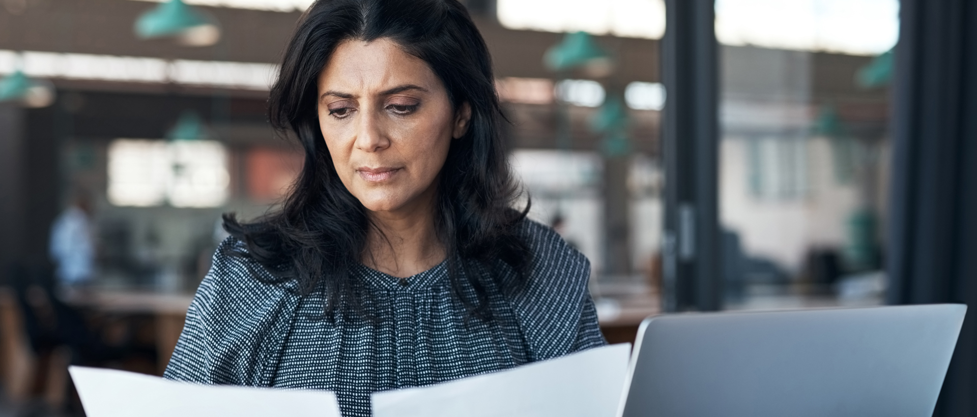 Woman reading tax documents.