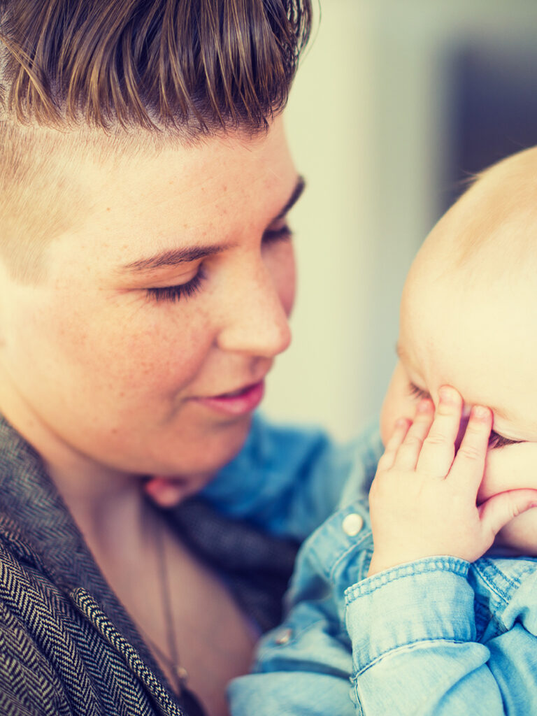 Mother holding infant child.