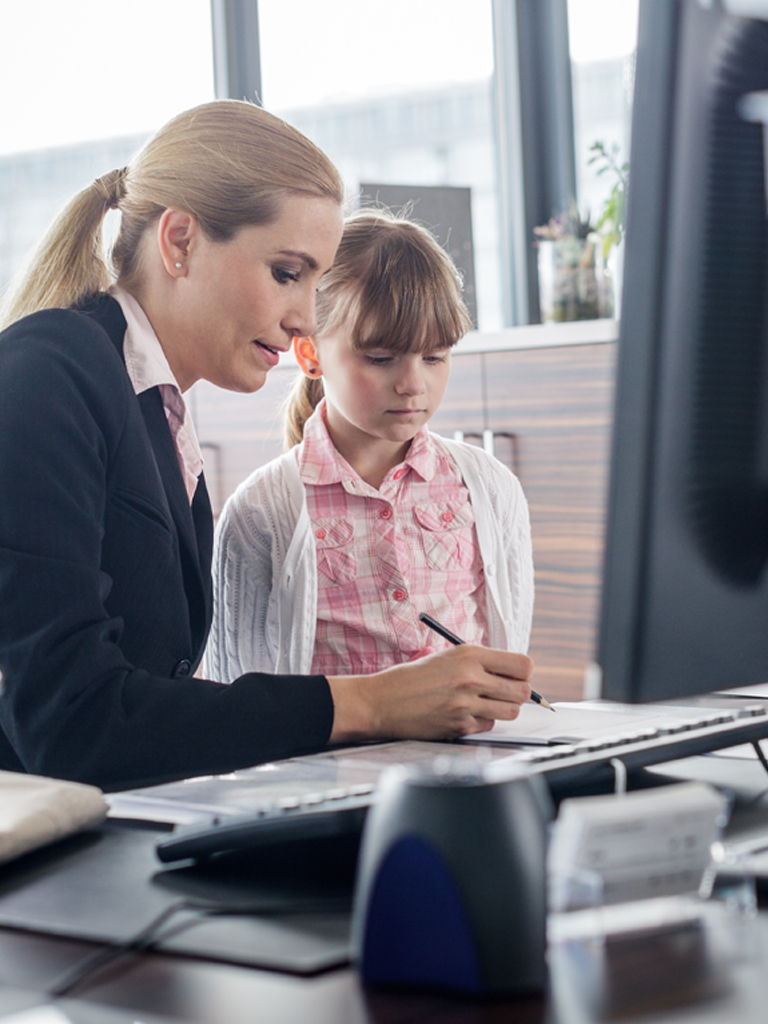 Mother helping daughter with homework.