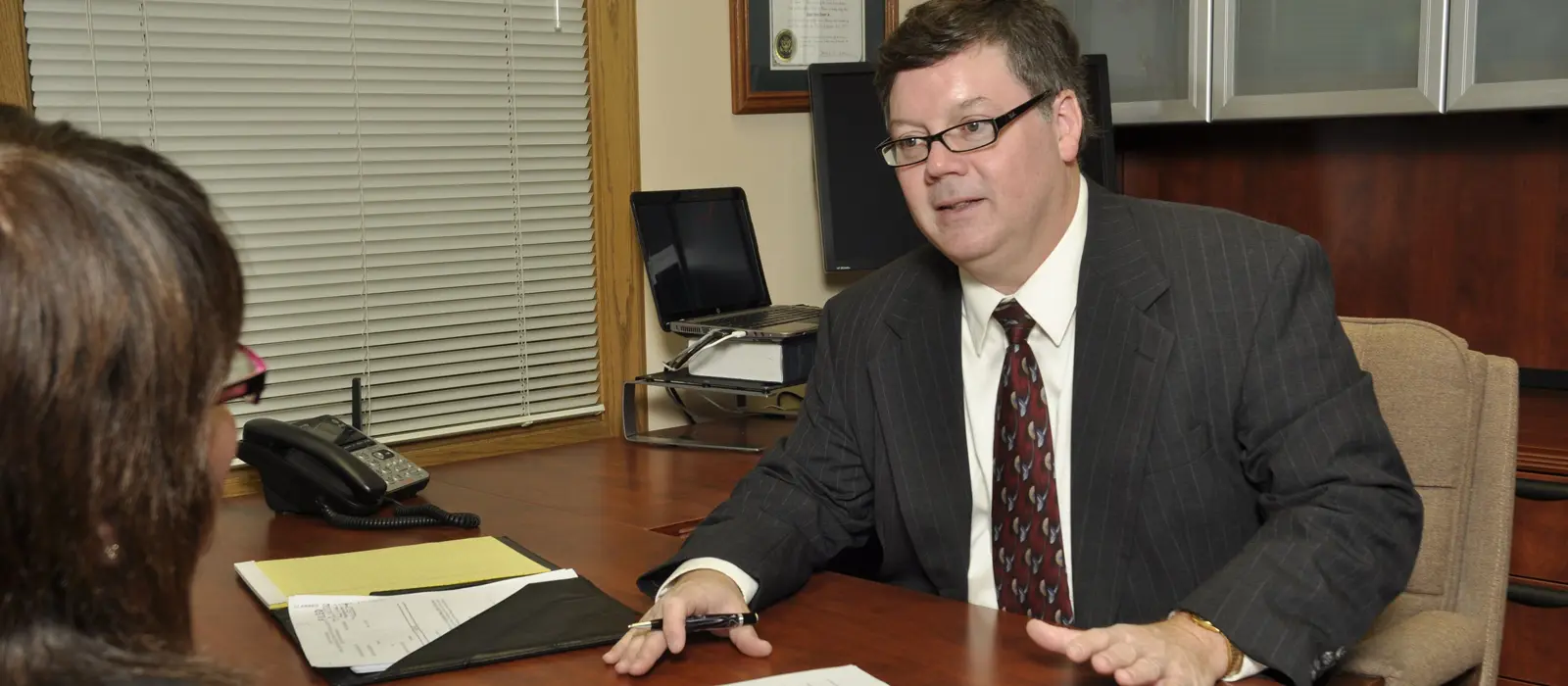 Attorney James O. Teeter, Jr. speaking with client.