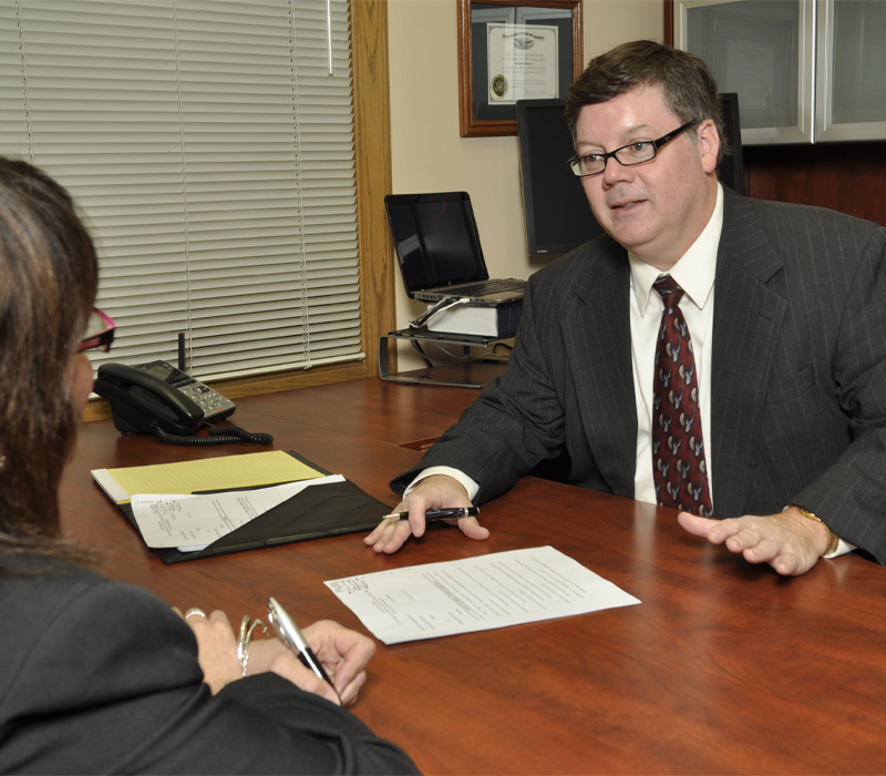 Attorney James O. Teeter, Jr. speaking with client.